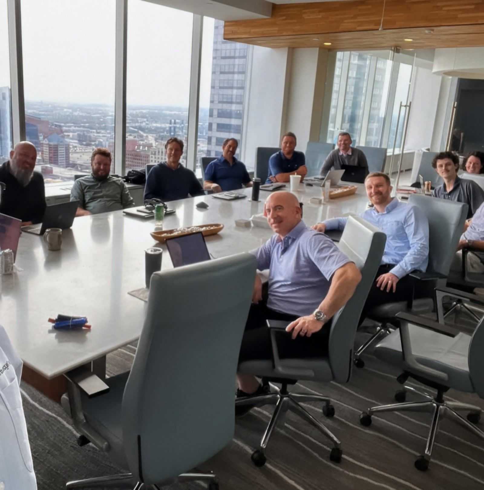 A boardroom of executives at Flaherty & Collins Properties in Indianapolis, laptops open, during a KnowledgeNet workshop