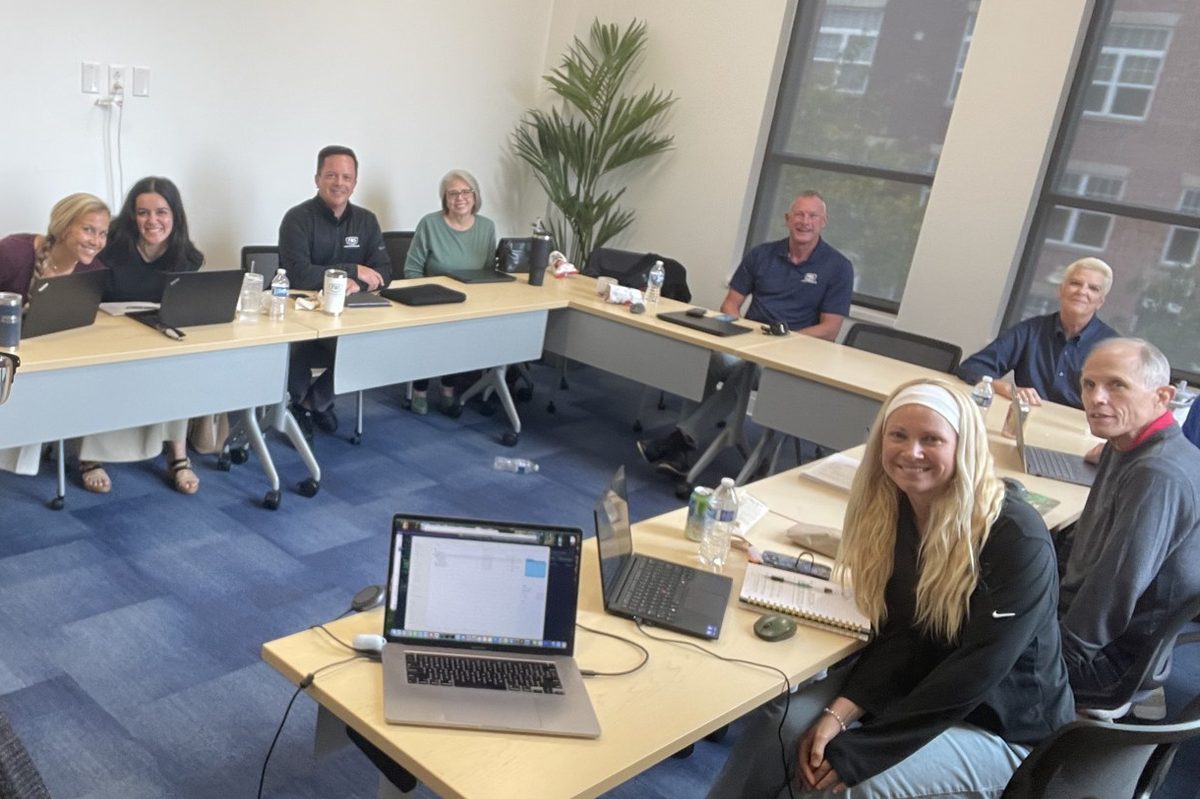 The FWS leadership team around a U-shaped table in Indianapolis